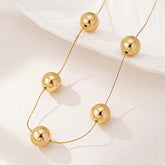 Golden Sphere Statement Necklace OutfitFlow